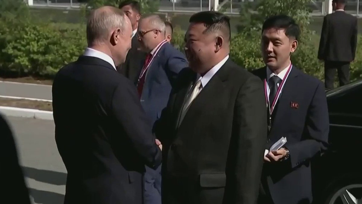 Putin shakes Kim Jong Un's hand