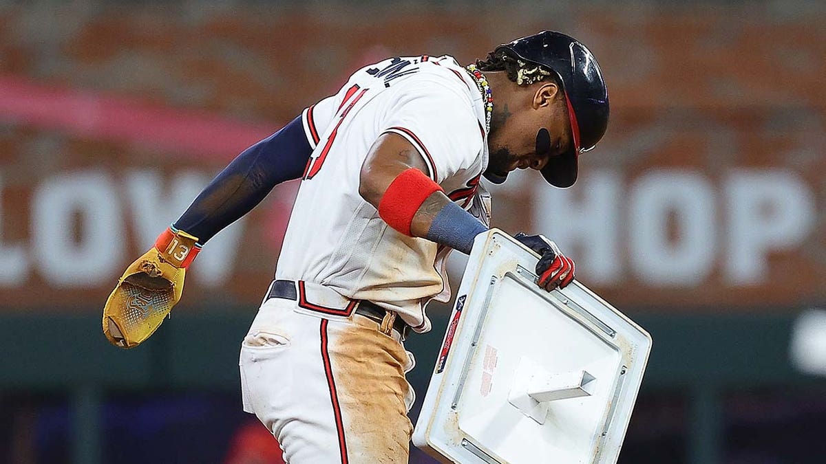 Ronald Acuna removes the base after stealing his 70th base of the season