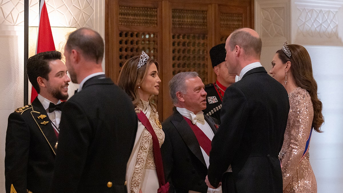 The royal family of Jordan in formal wear chatting with the Prince and Princess of Wales