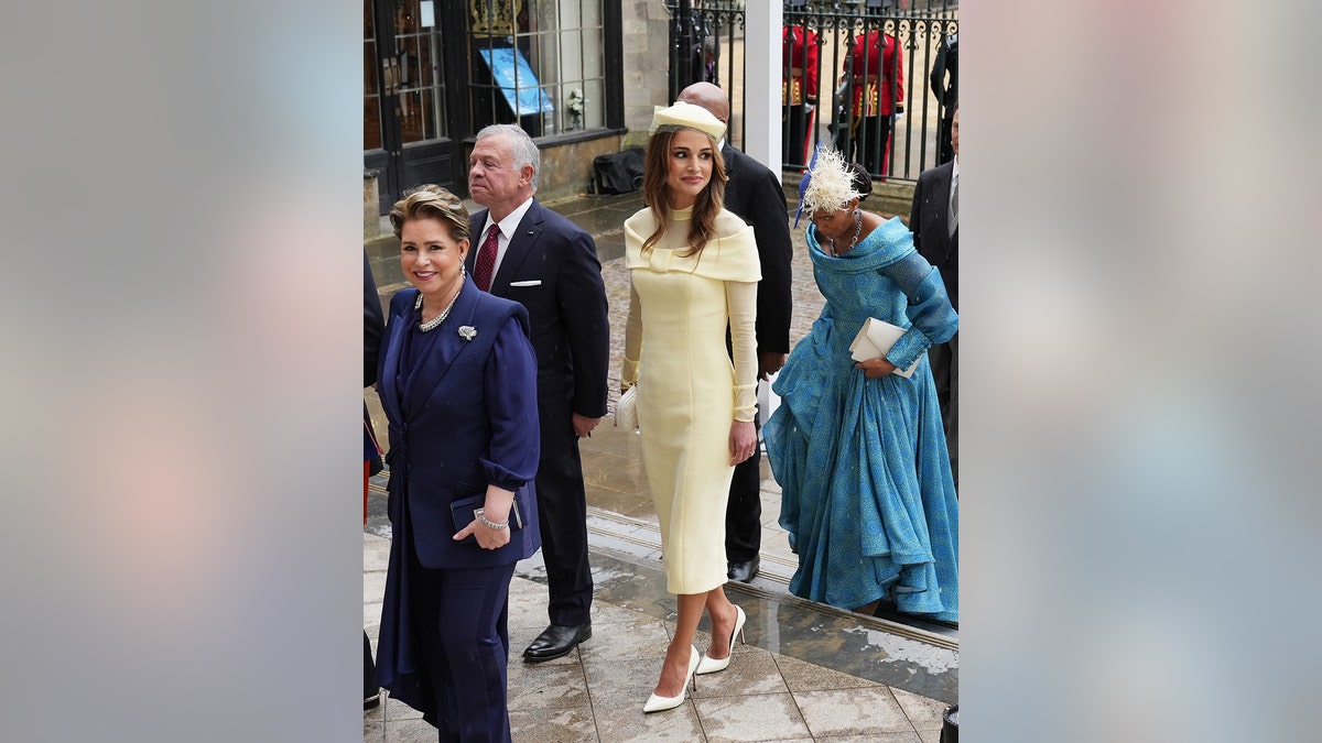 Queen Rania of Jordan wearing a yellow dress with a matching hat