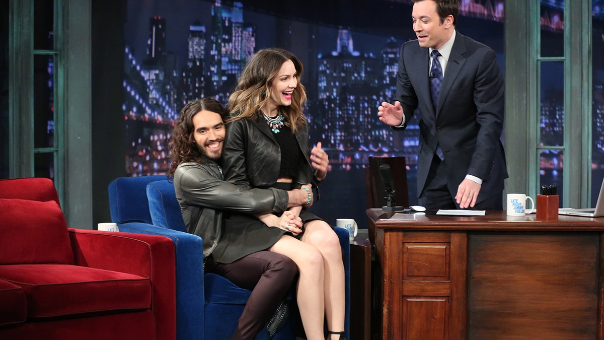 Russell Brand pulls Katharine McPhee into his lap