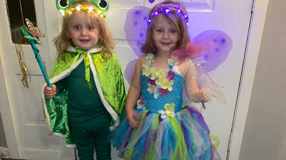Twins dressed in Halloween costumes.