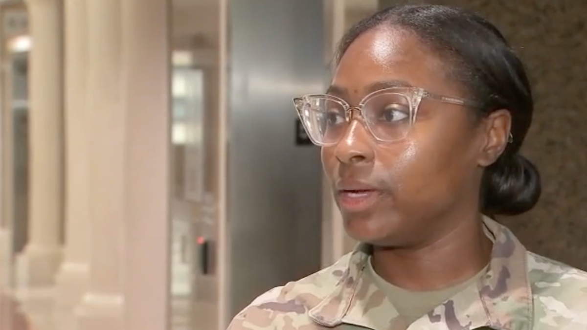 An Army reservist conducts an interview as she deals with squatters