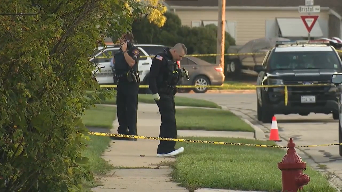 Police officers standing on sidewalk