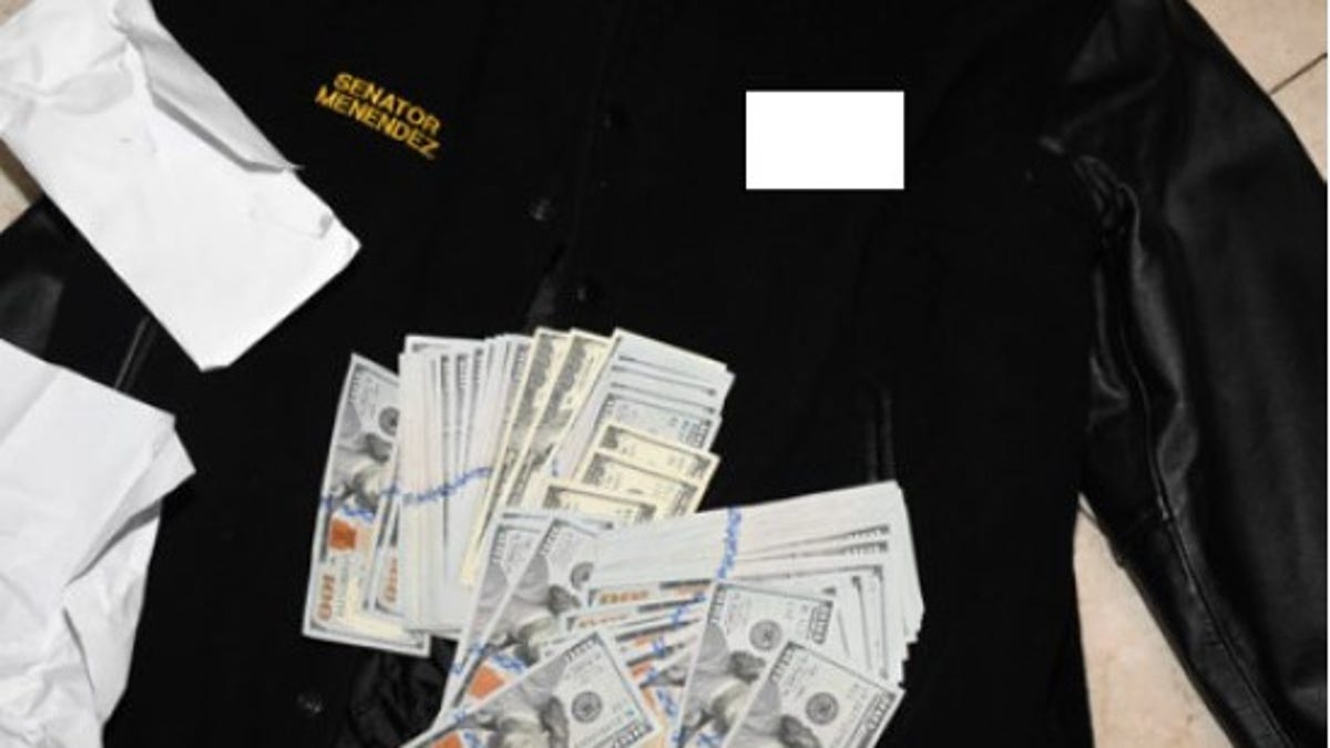 An image captured by federal investigators and attached to the indictment Friday shows cash that was found stuffed into Menendez's jacket in his home.