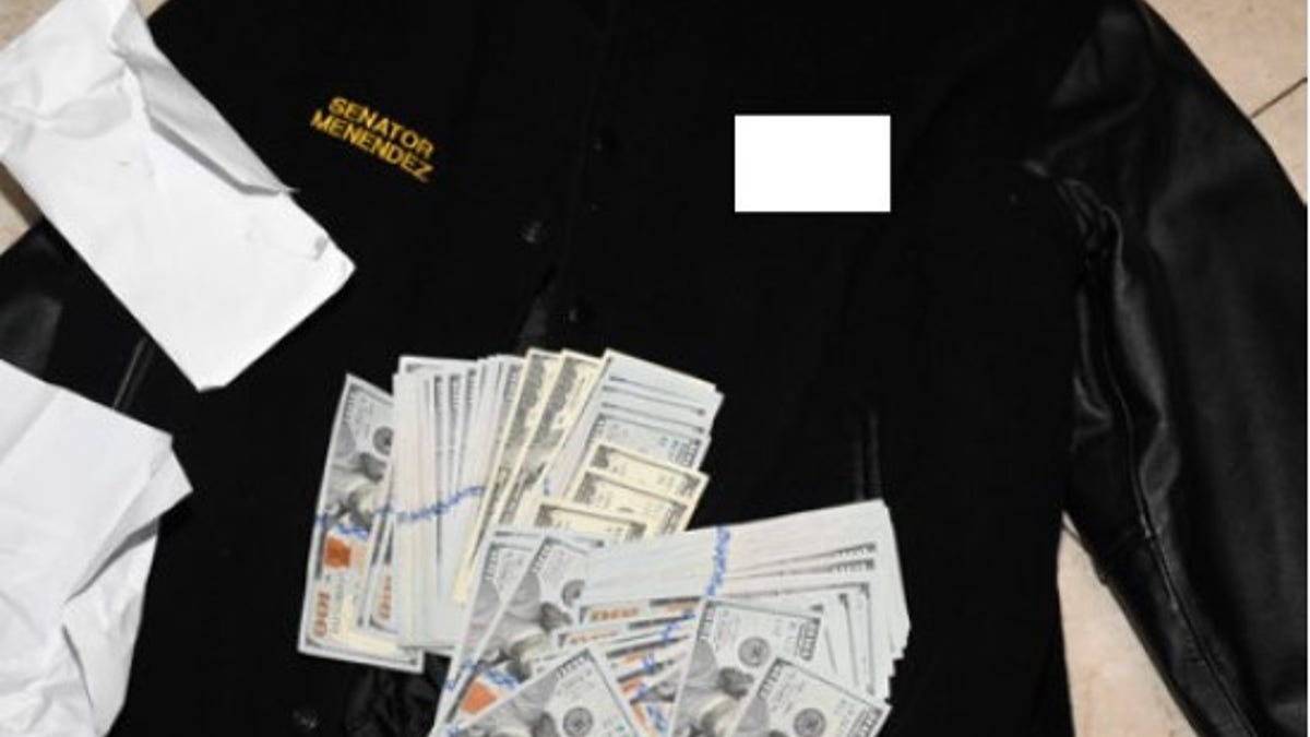 An image captured by federal investigators and attached to the indictment Friday shows cash that was found stuffed into Menendez's jacket in his home.