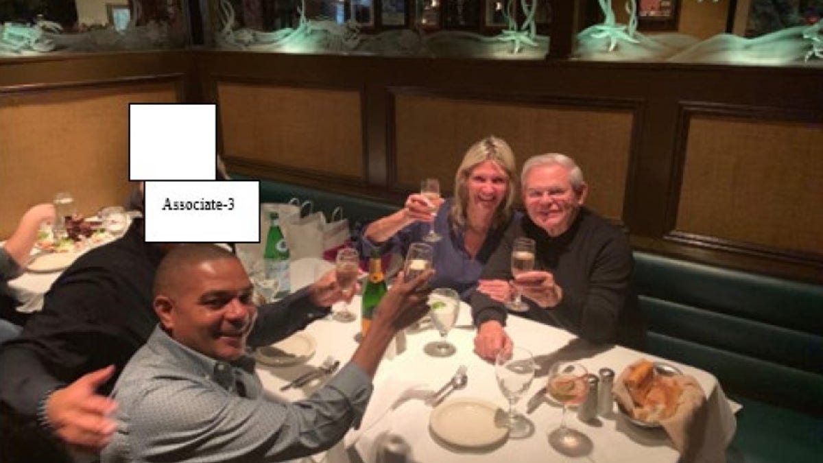 Menendez is pictured with his wife Nadine in 2019 with businessman Jose Uribe, who was also charged Friday, during a celebratory dinner.