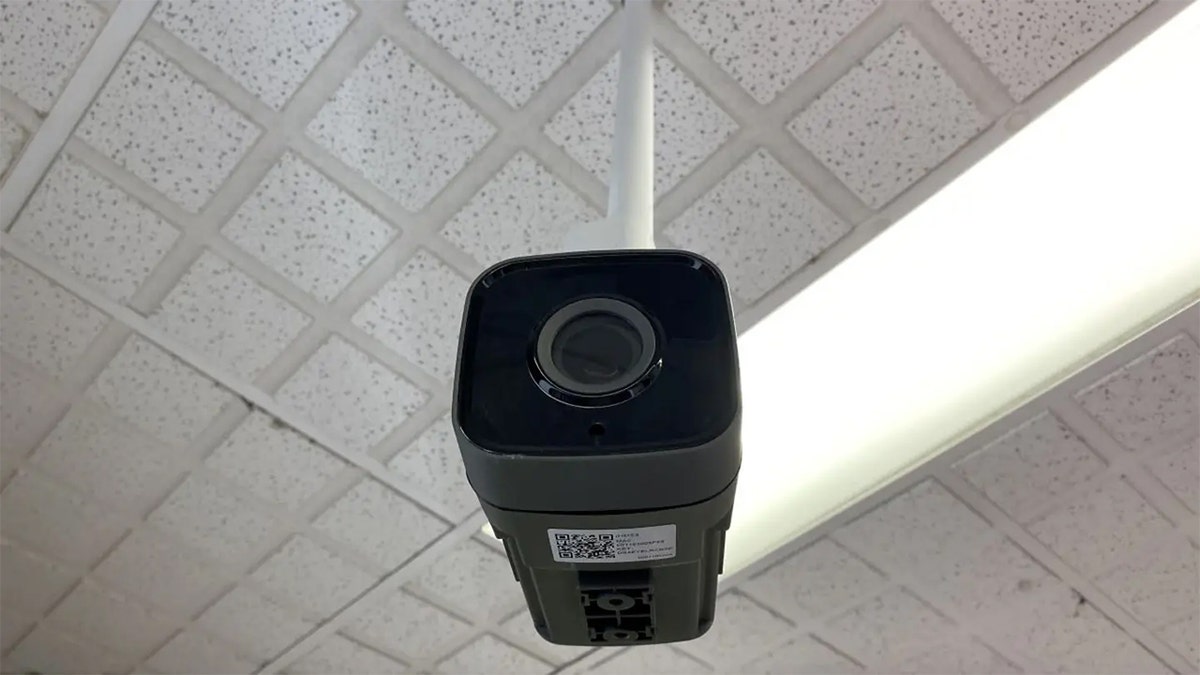 Security camera hanging from the ceiling.