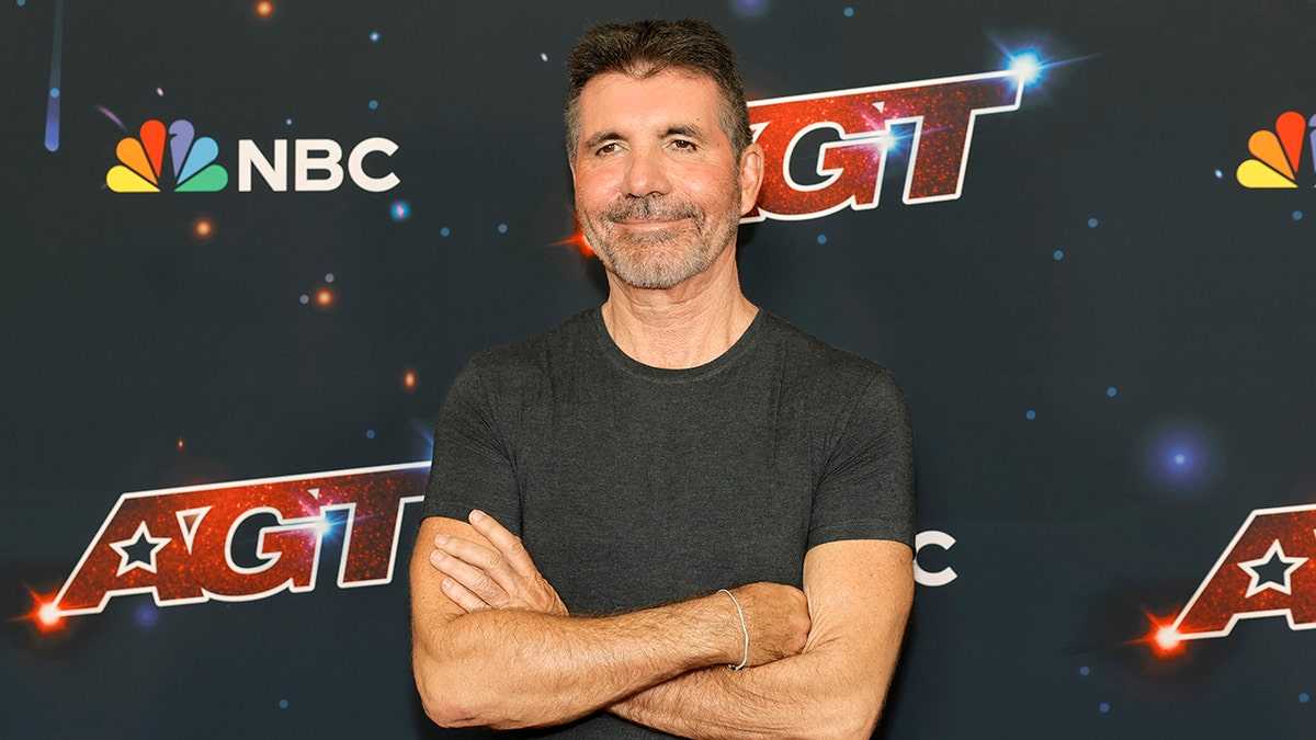Simon Cowell posing with his arms crossed