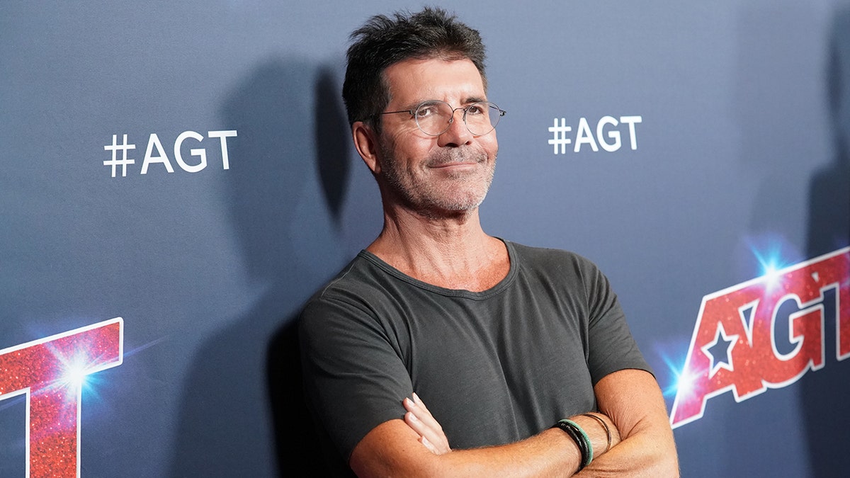 Simon Cowell posing on red carpet