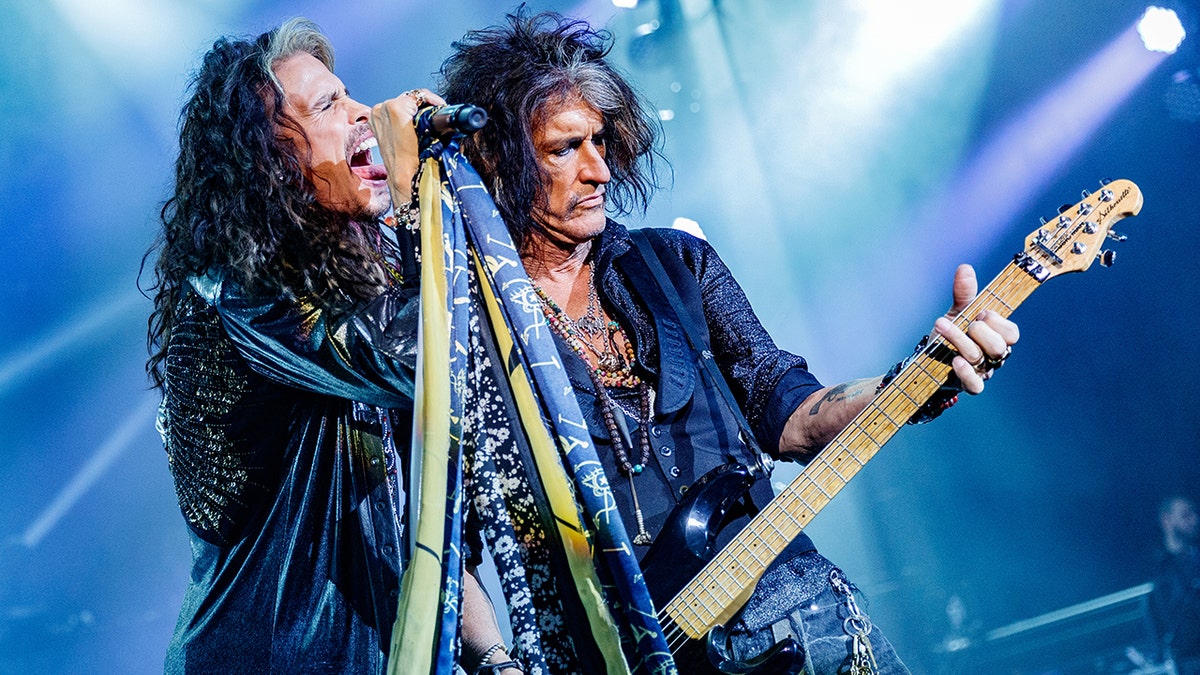 Steven Tyler and Joe Perry performing together on stage