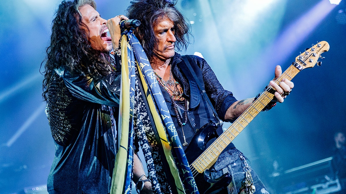 Steven Tyler and Joe Perry performing together on stage