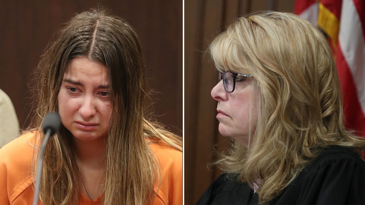 Woman in orange jumpsuit sits at defense table.