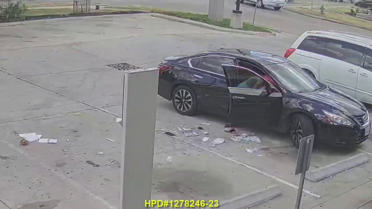 Suspect reaching into victim's car