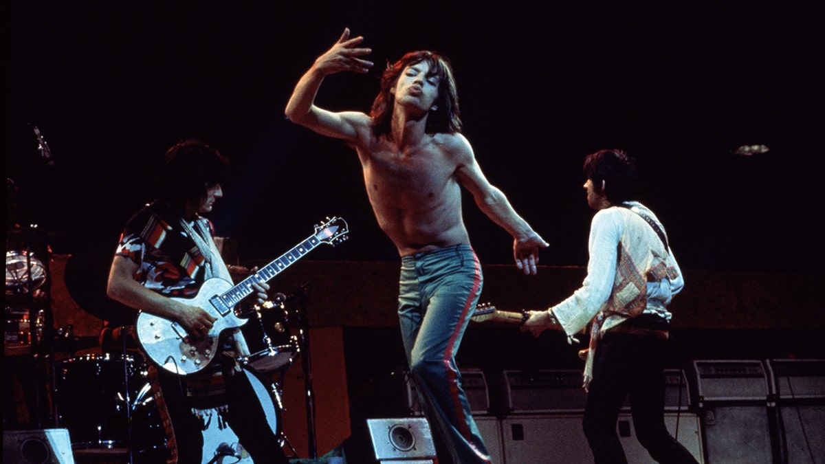 Vintage photo of Ronnie Wood, Mick Jagger, and Keith Richards performing on stage