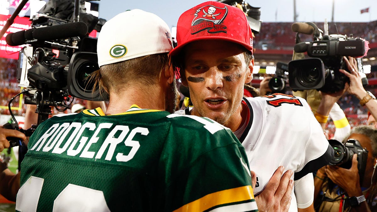 Tom Brady talks to Aaron Rodgers