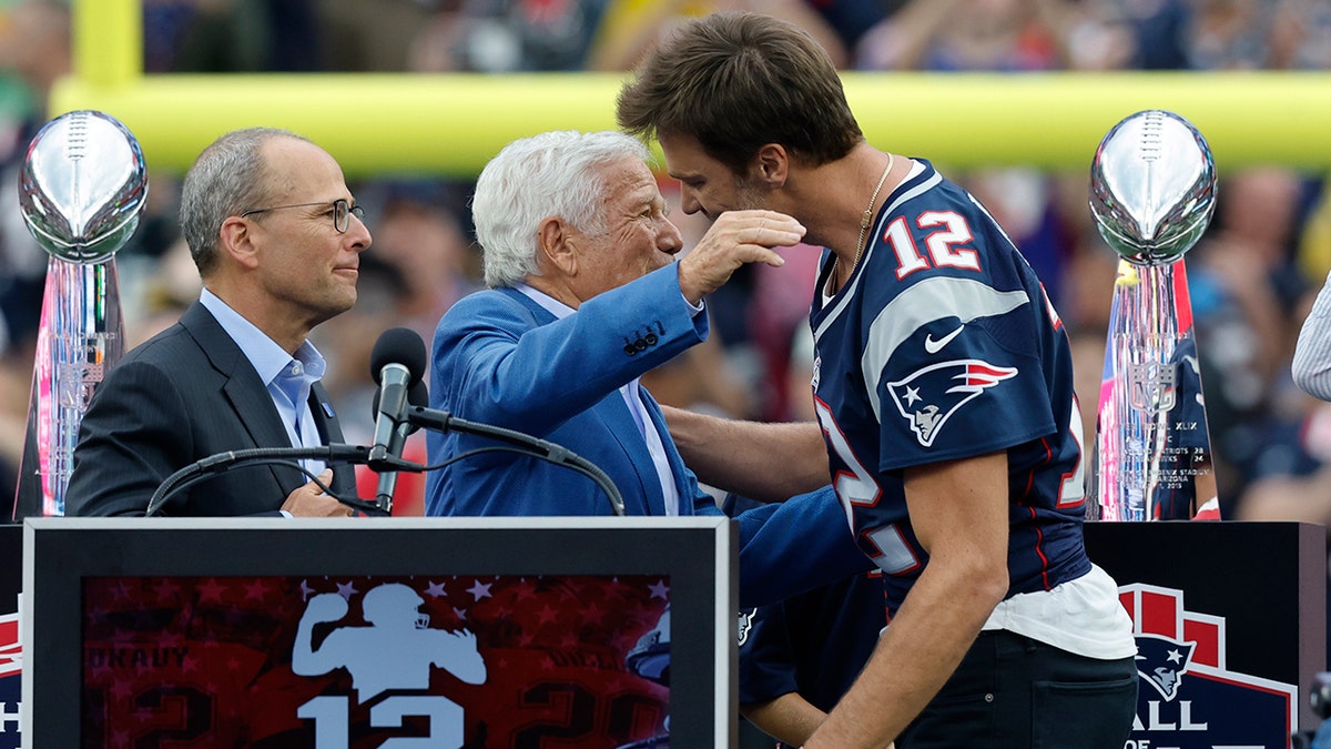Tom Brady hugs Robert Kraft