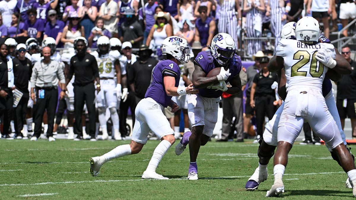 Trey Sanders carries the football for TCU