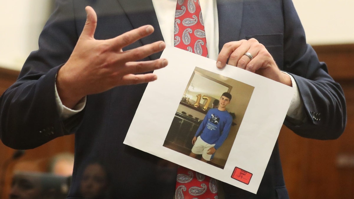Summit County Assistant Prosecutor Matt Kuhn holds a photo of Ethan Liming as he gives his closing argument in trial of DeShawn and Tyler Stafford in the death of Ethan Liming in Summit County Common Pleas Judge Tammy O'Brien's courtroom.