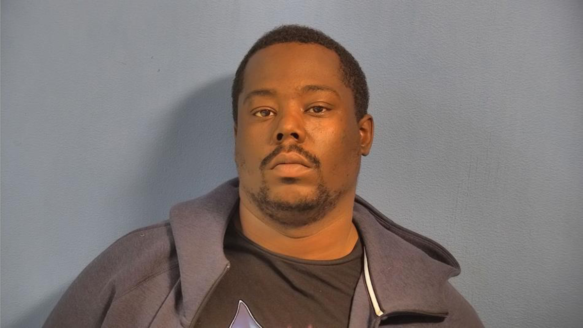 Terry Johnson stands emotionless in an Illinois booking picture