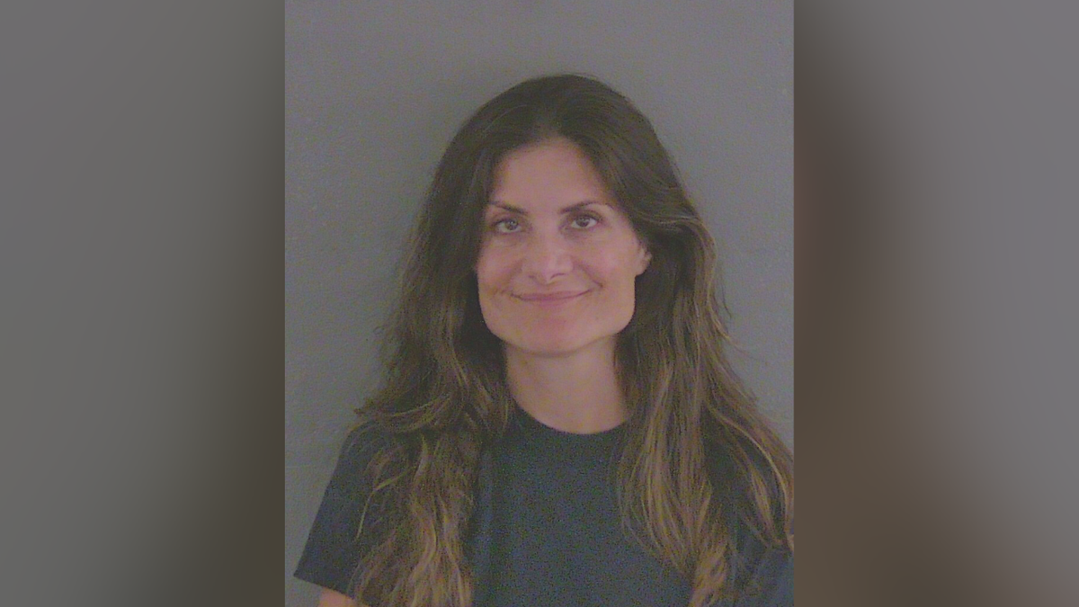 Amanda Ferragamo smirks in a Florida booking picture