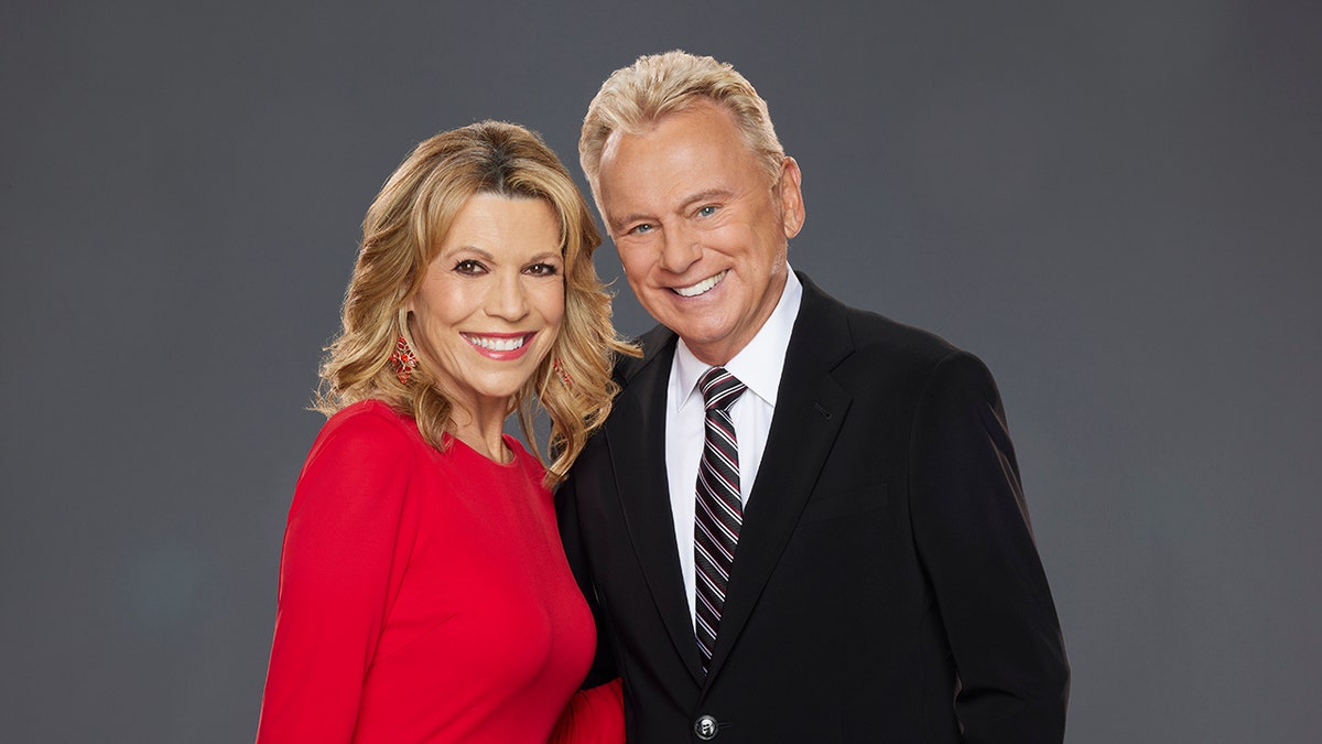 Vanna White and Pat Sajak pose for a photo