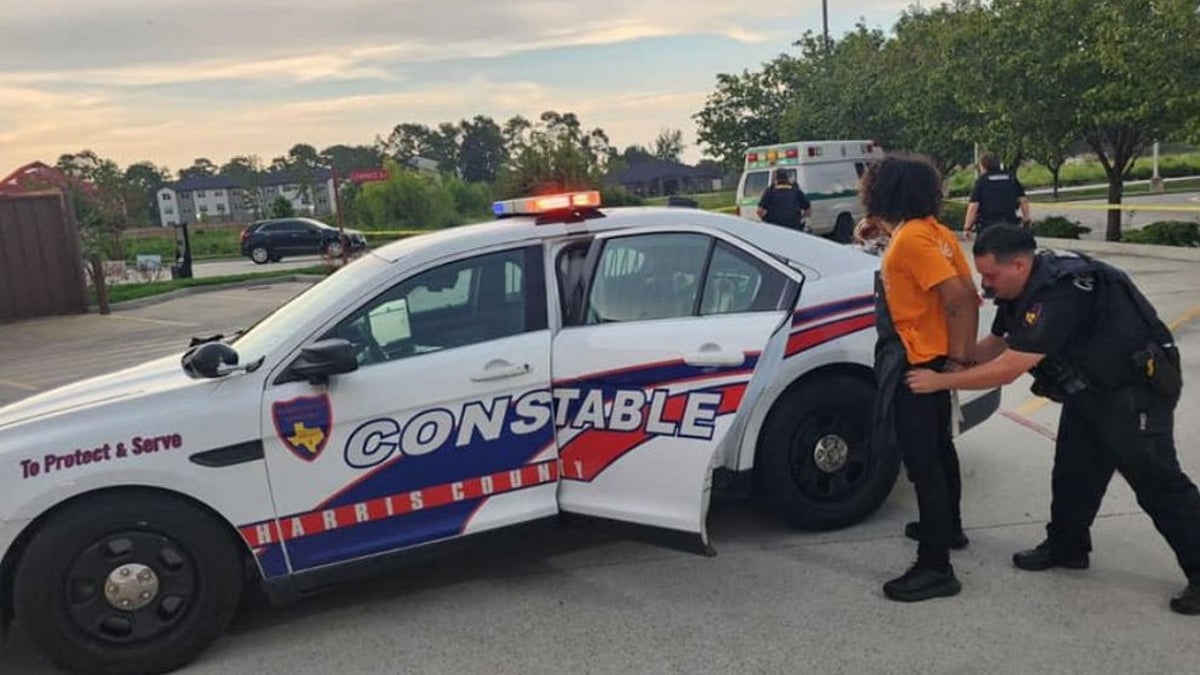 Deputies arrest Yadiel Gonzalez while in his Popeyes uniform in a parking lot next to a police vehicle.