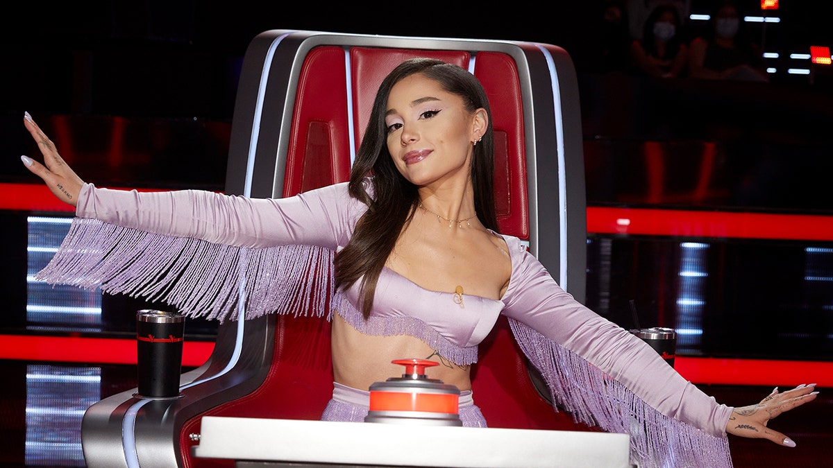 Ariana Grande sits in judges chair on The Voice.