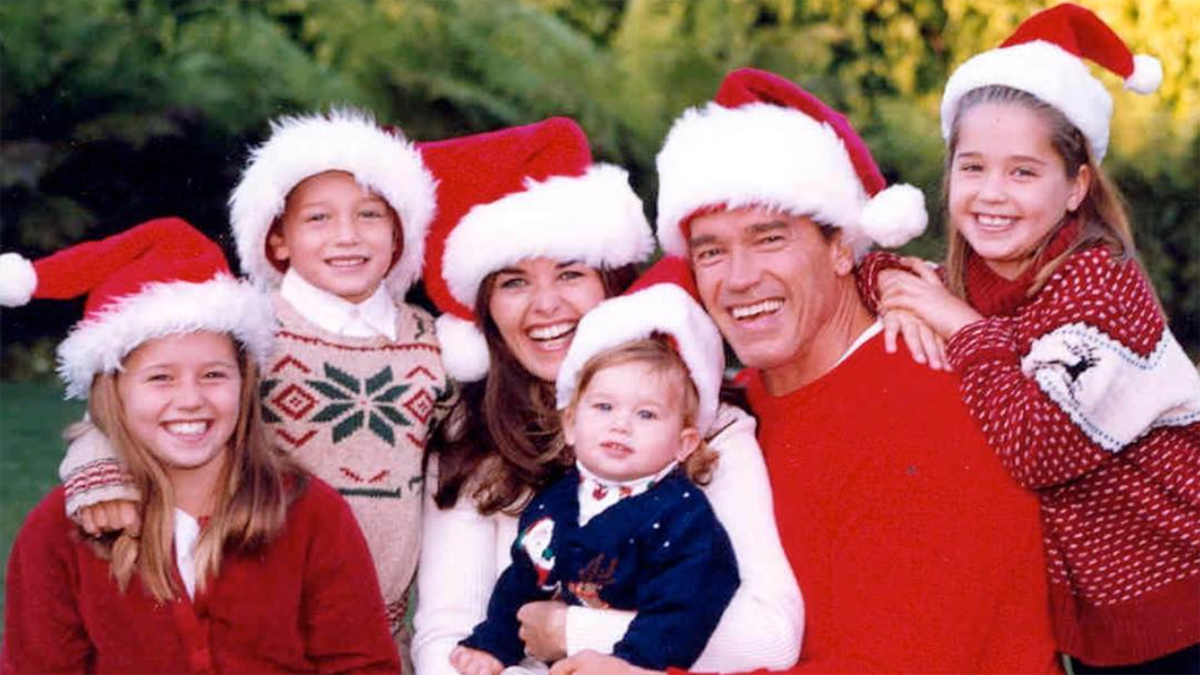 Arnold Schwarzenegger and his four young kids and wife Maria Shriver all pose for a holiday picture in Santa hats
