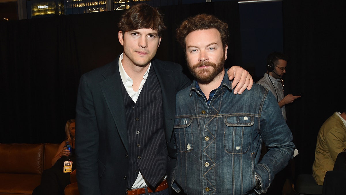 Ashton Kutcher puts his arm around Danny Masterson at the 2017 CMT Music Awards