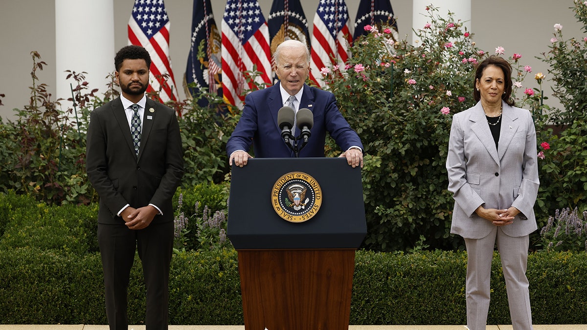 President Biden speaking next to Maxwell Frost and Kamala Harris