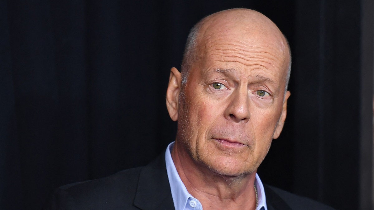 Bruce Willis looks slightly perplexed as he appears in front of the camera for a photo