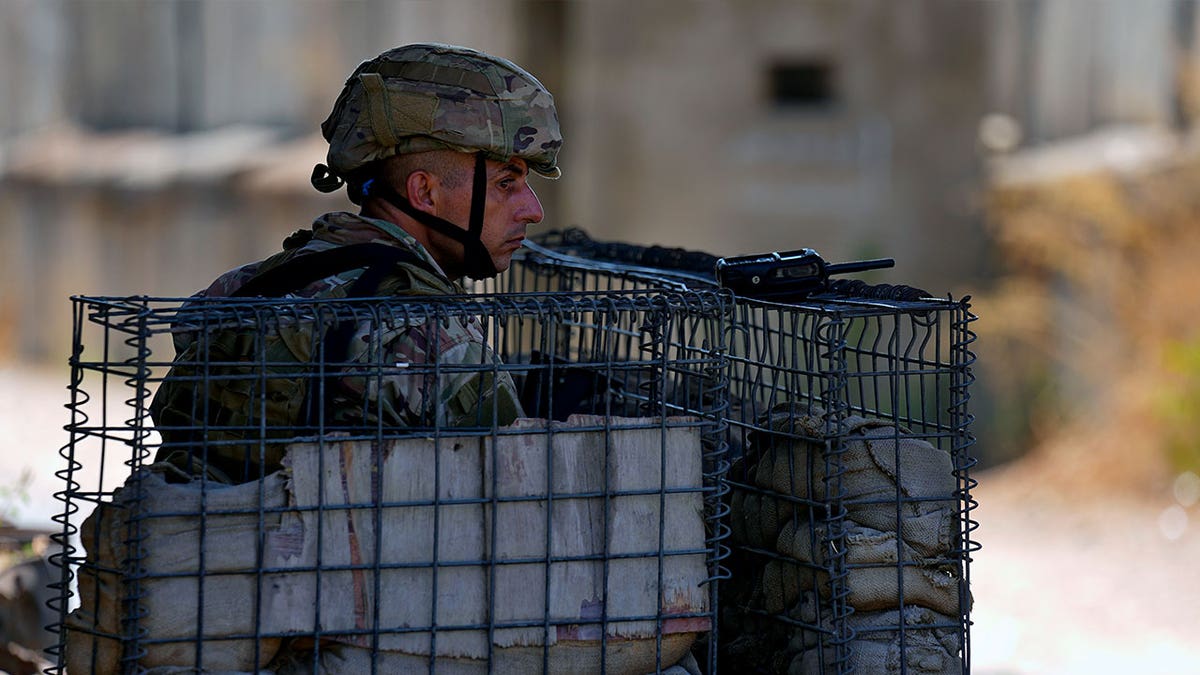 soldier behind fence on guard