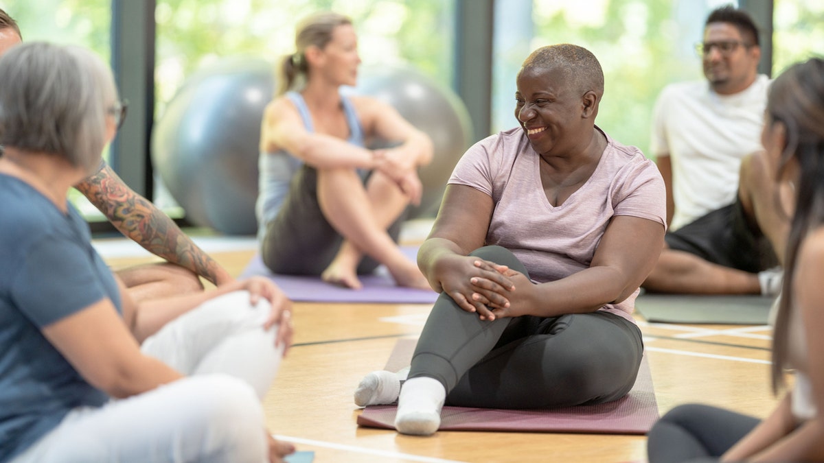 people talking to each other during yoga class