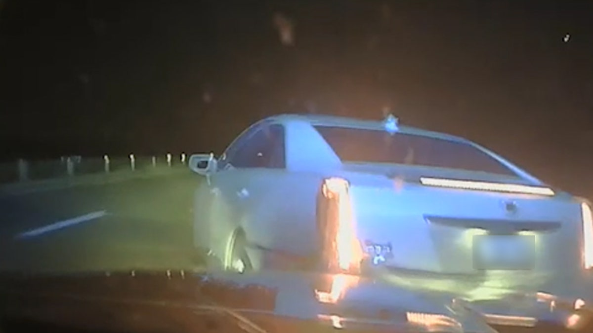 Arkansas Police car drives behind white car on highway and hits it