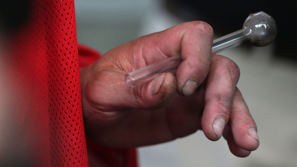 Man holding a crack pipe