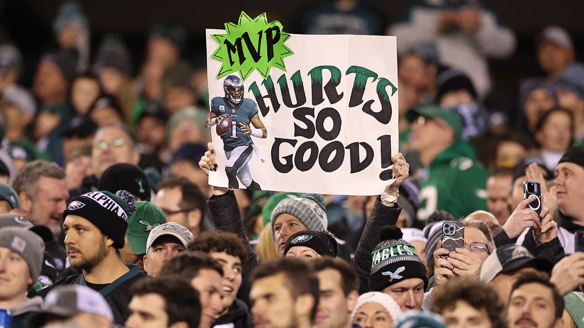 Eagles fans hold a sign