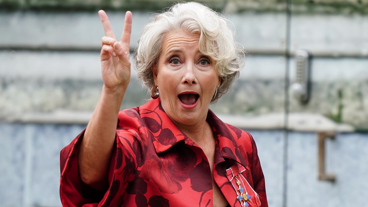 Emma Thompson giving a peace sign to the camera