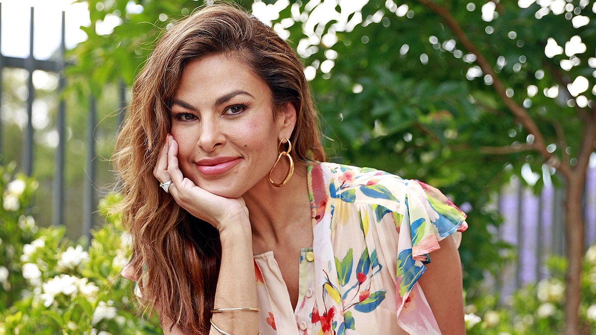Eva Mendes posing in a floral dress