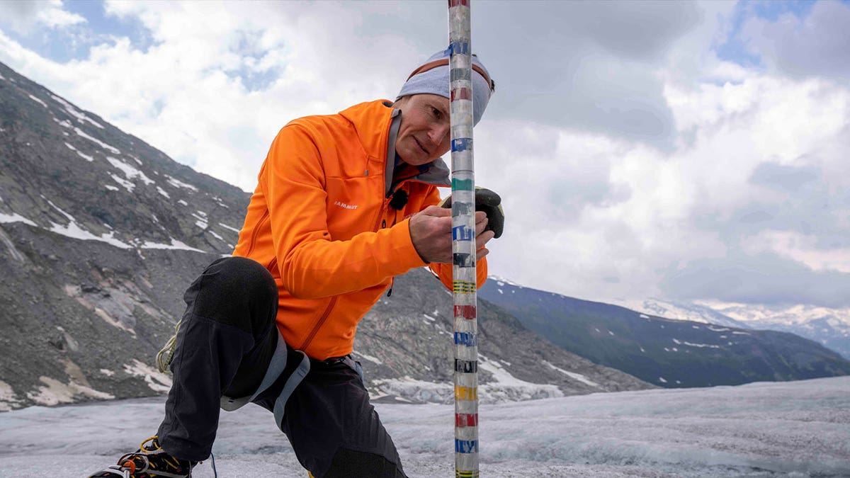 geologist measures glacier