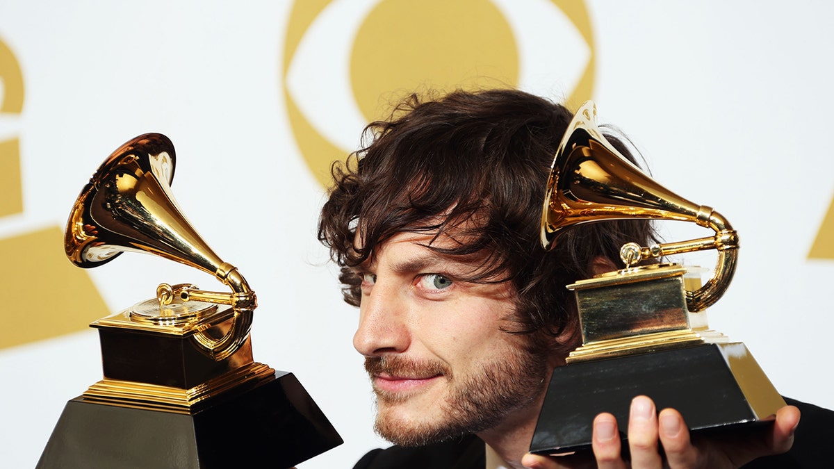 Gotye holding two Grammy Awards