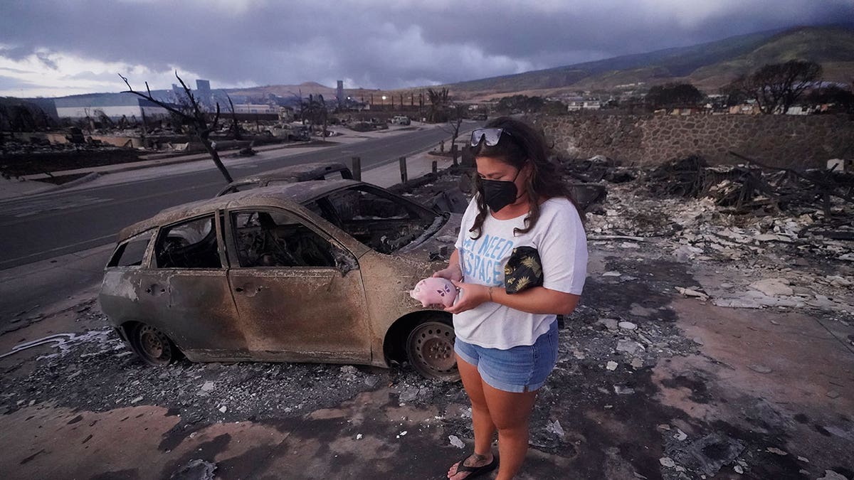 girl picks up piggy bank found in aftermath of Hawaii's wildfire