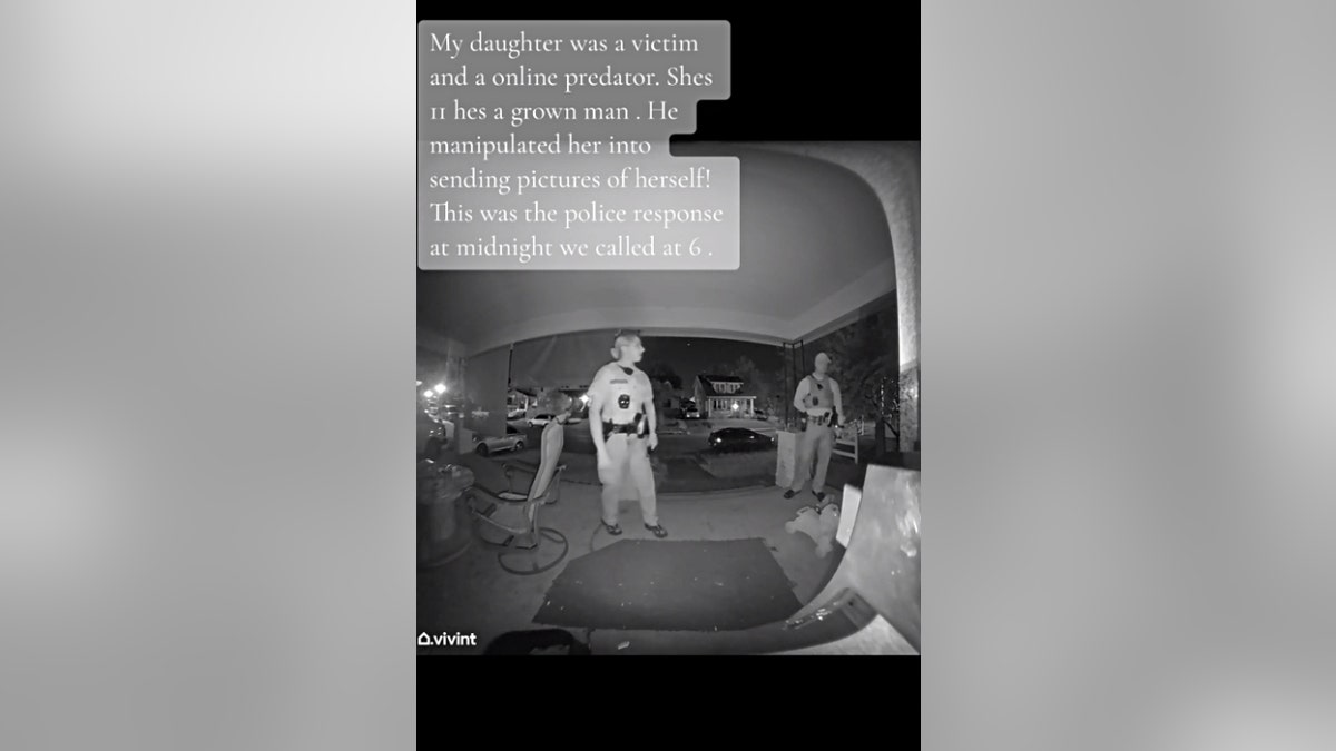 The female Columbus police officer (left) and male Columbus police officer (right) stand outside a man's home