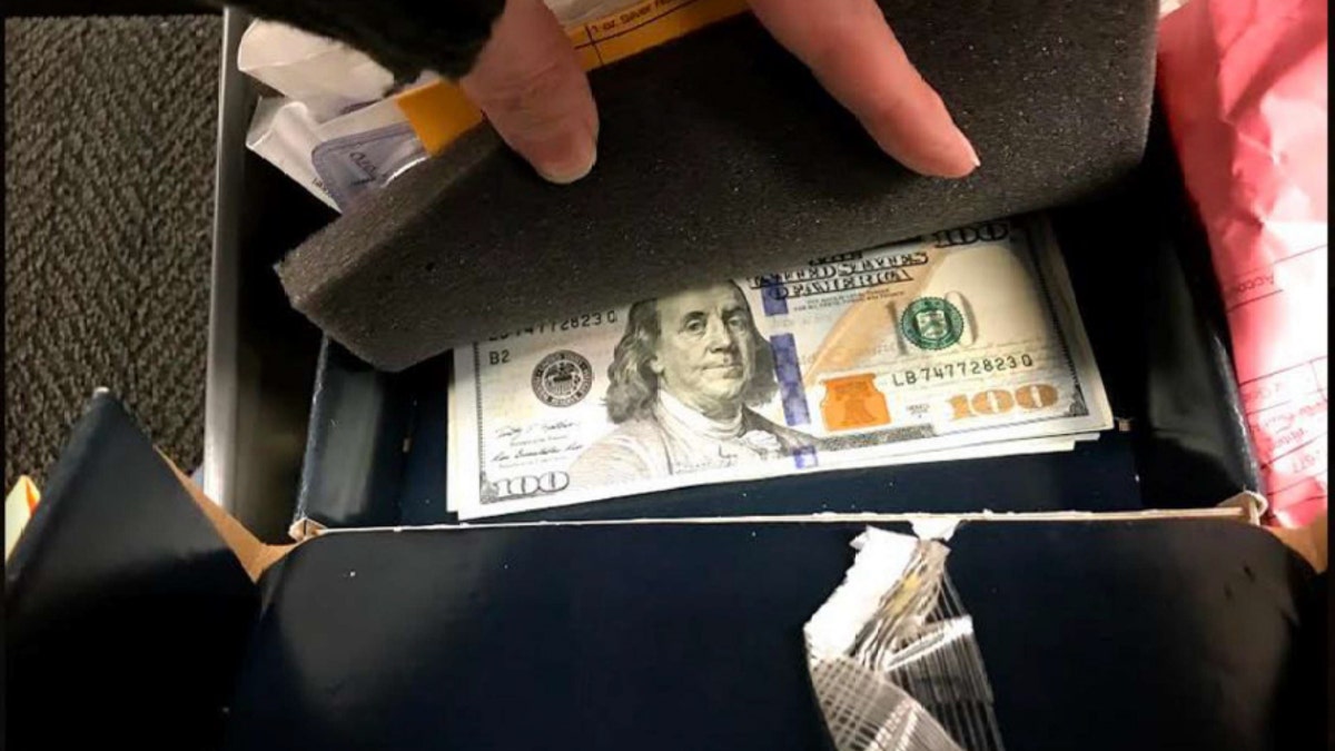 photo of cash under a foam lining stored in jeni pearsons safety deposit box