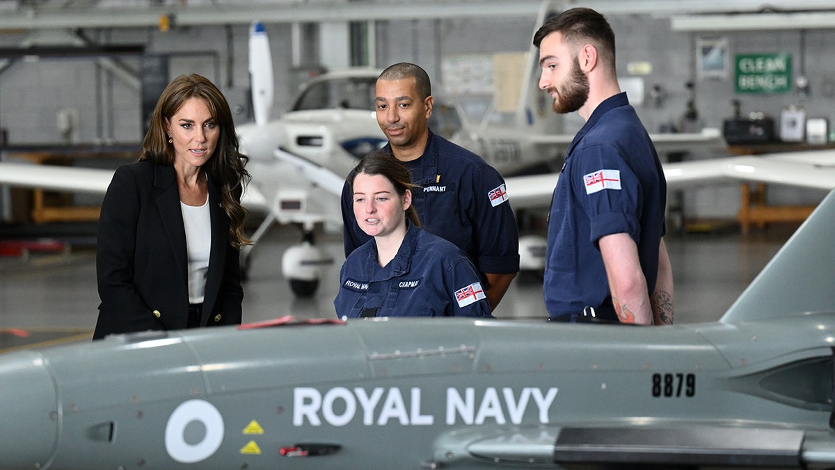 Kate Middleton looks at machinery in the hangar