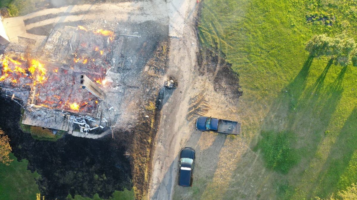 Drone shot of burning farm
