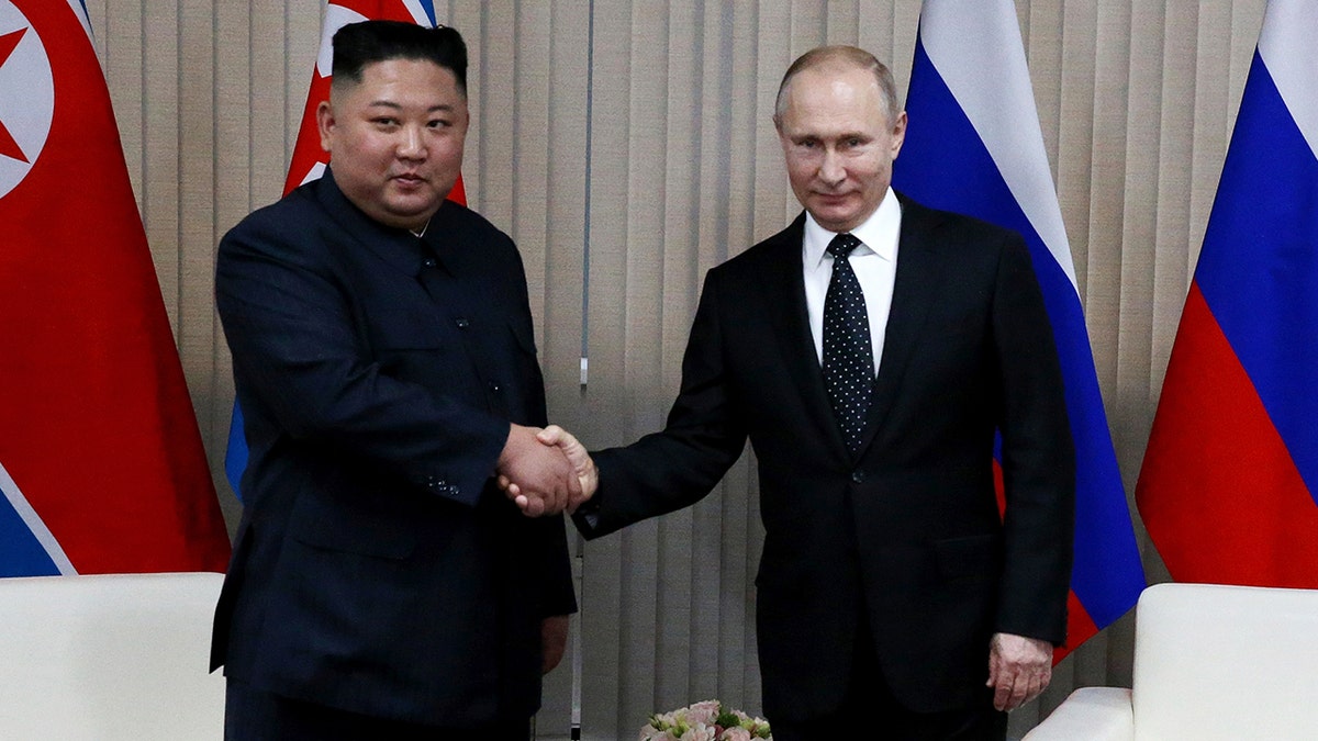 Kim Jong-un and Putin shaking hands