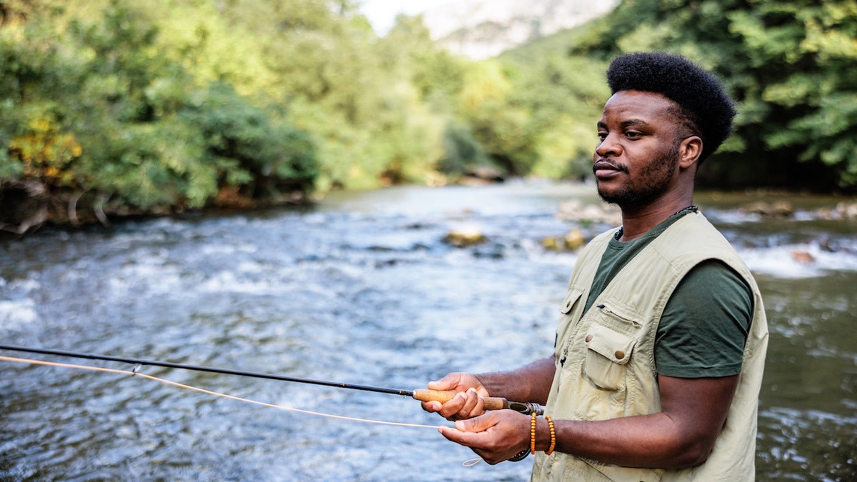 Man fishing in creek