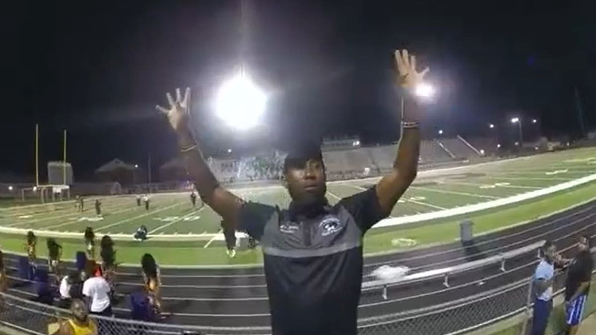 Johnny Mims conducting band with hands raised