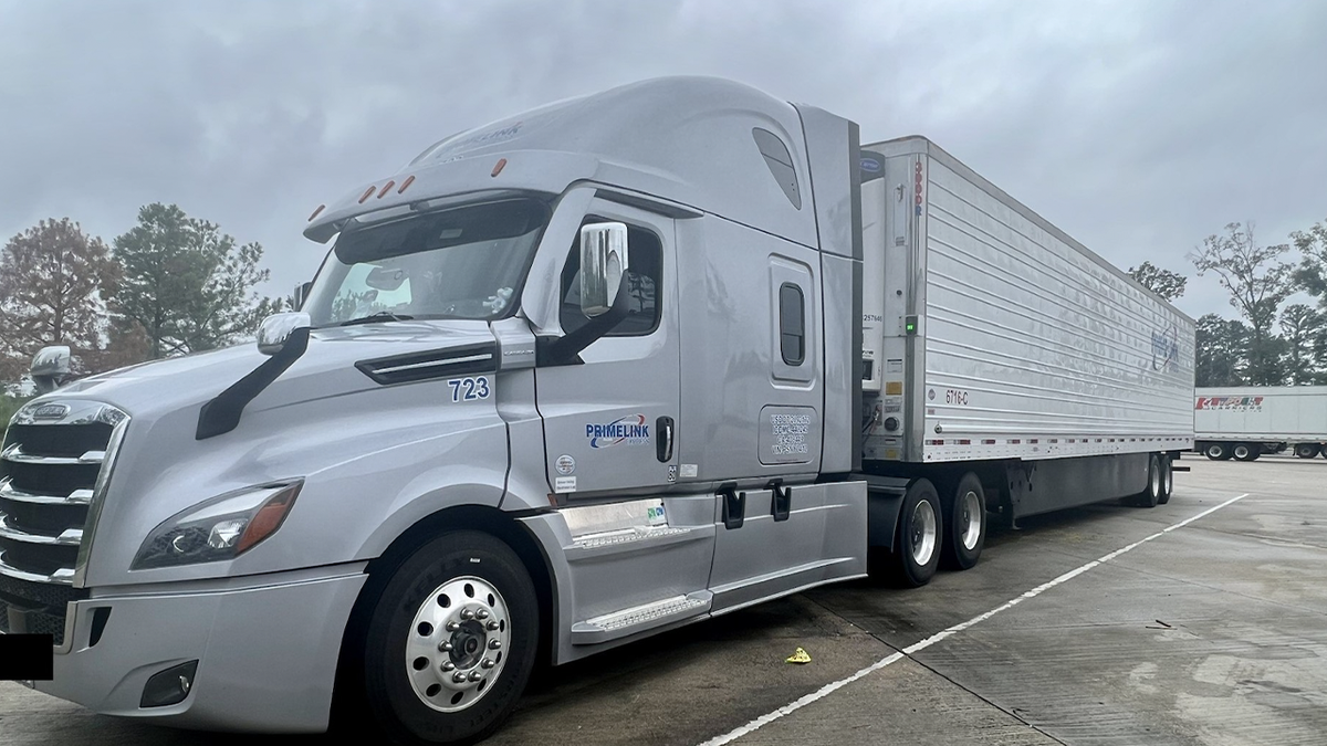 Maybi Izquierdo's gray tractor-trailer